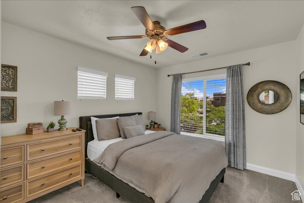 Bedroom with carpet floors, baseboards, and a ceiling fan