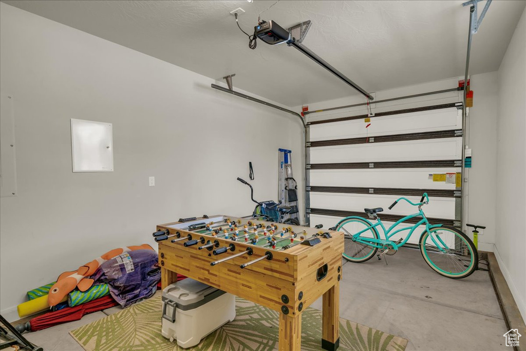 Game room featuring concrete flooring and a garage