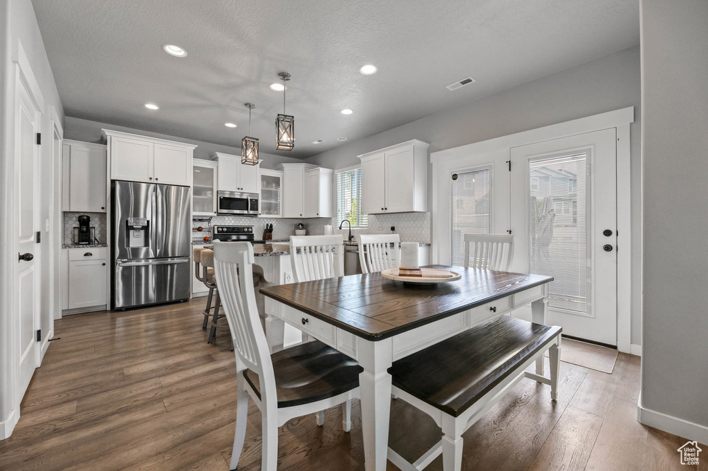 Dining space featuring recessed lighting, dark wood-style flooring, and baseboards