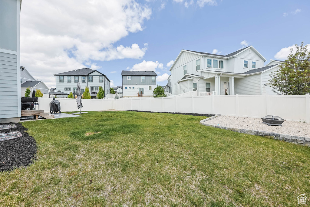 View of yard featuring a residential view, a fire pit, and a patio area