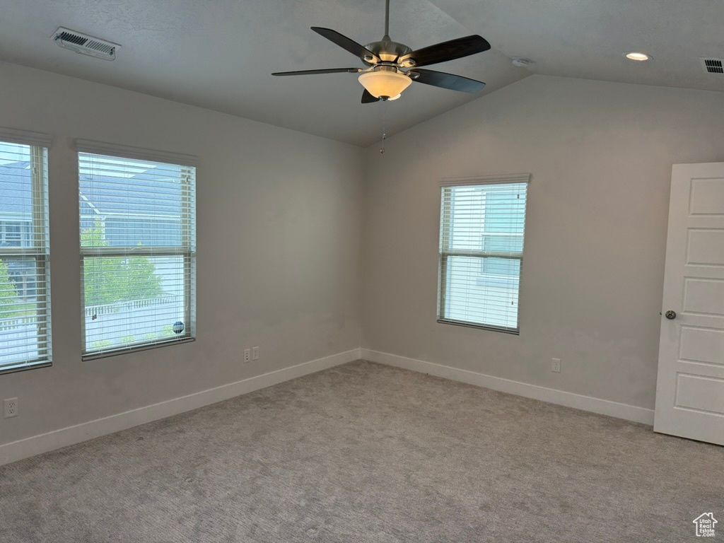 Spare room with a ceiling fan, light carpet, baseboards, vaulted ceiling, and recessed lighting