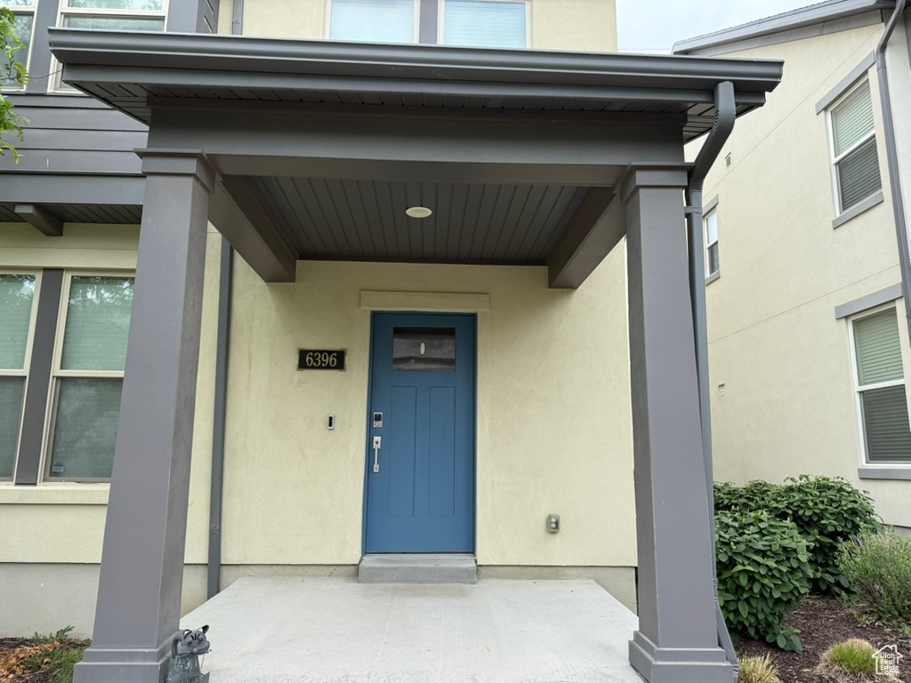Doorway to property with stucco siding