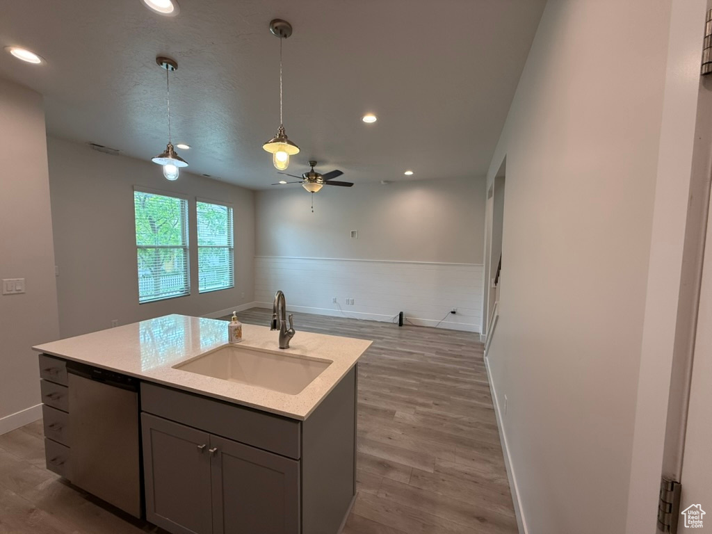 Kitchen with a sink, dishwasher, open floor plan, recessed lighting, and decorative light fixtures