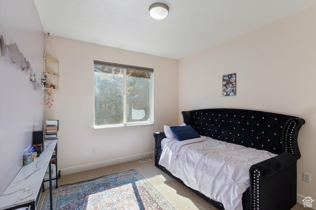 Bedroom featuring carpet flooring and baseboards