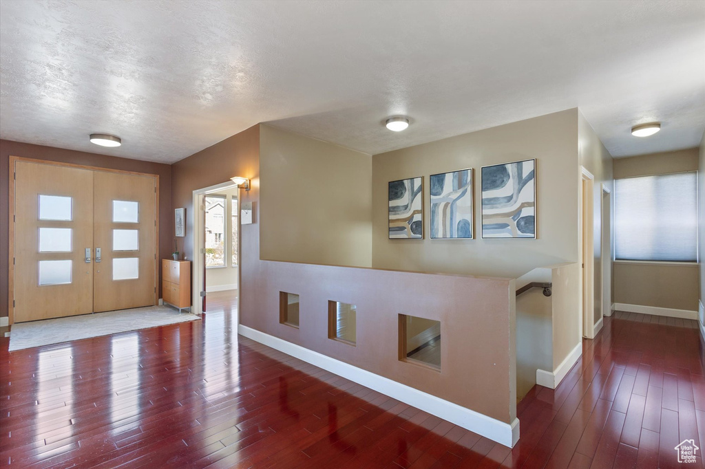 Foyer with baseboards, hardwood / wood-style flooring, and french doors