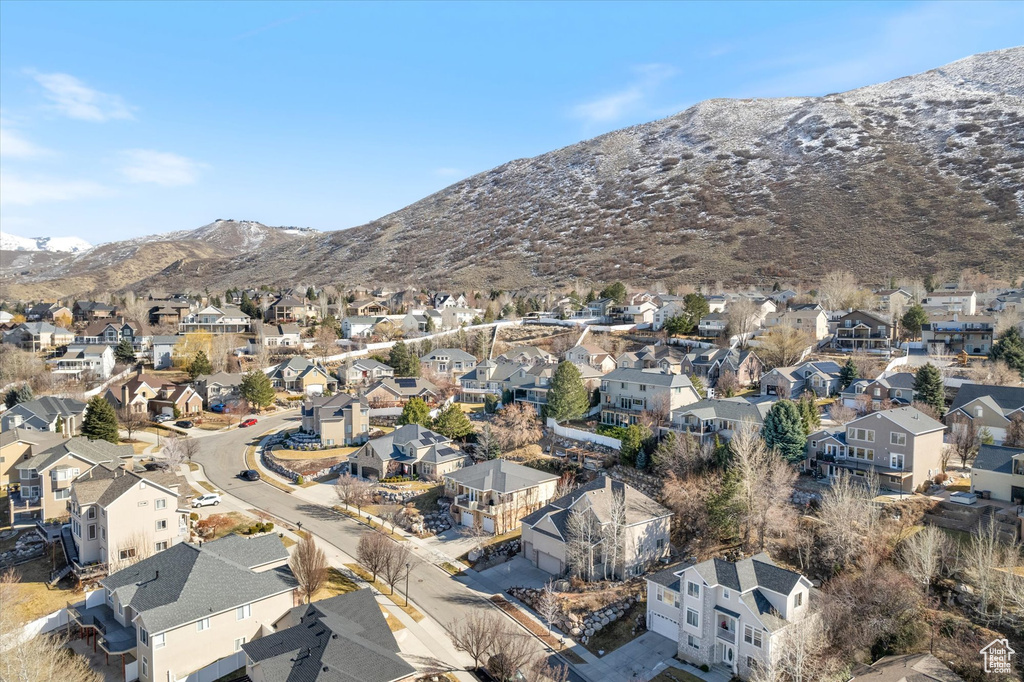 Aerial view of property's location with mountains and nearby suburban area