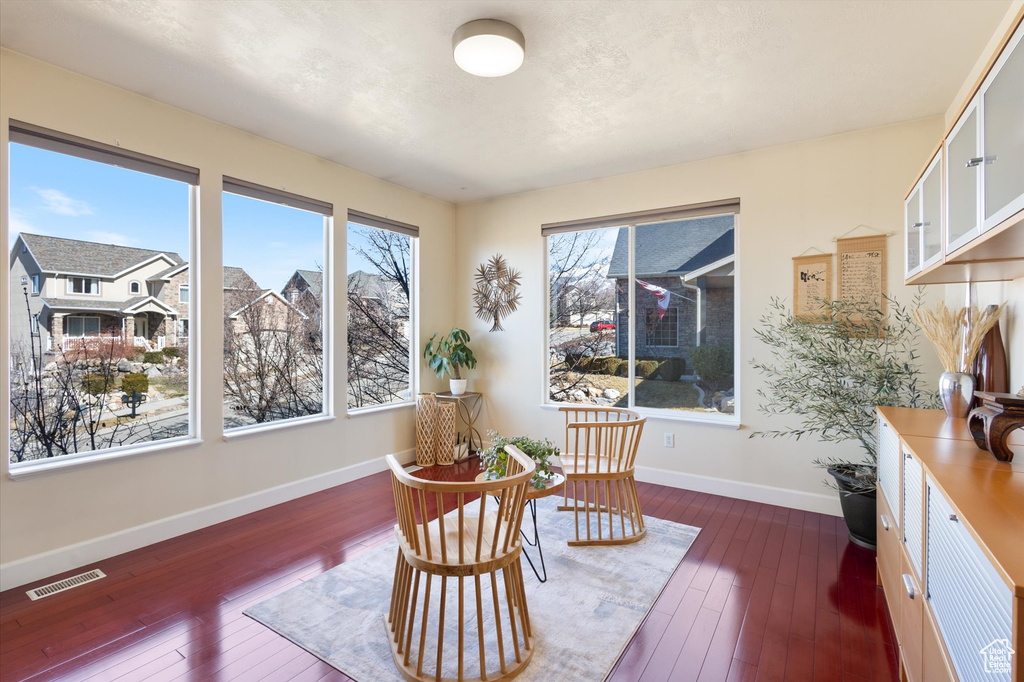 Sitting room with dark wood-style floors and baseboards