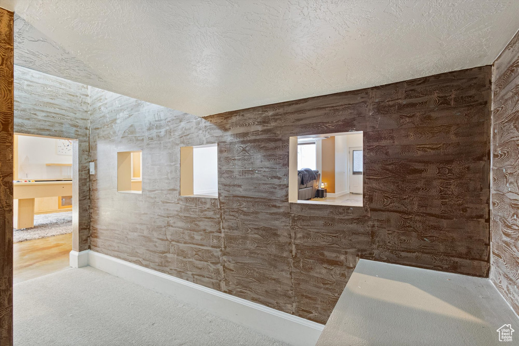 Bathroom with a textured ceiling and baseboards