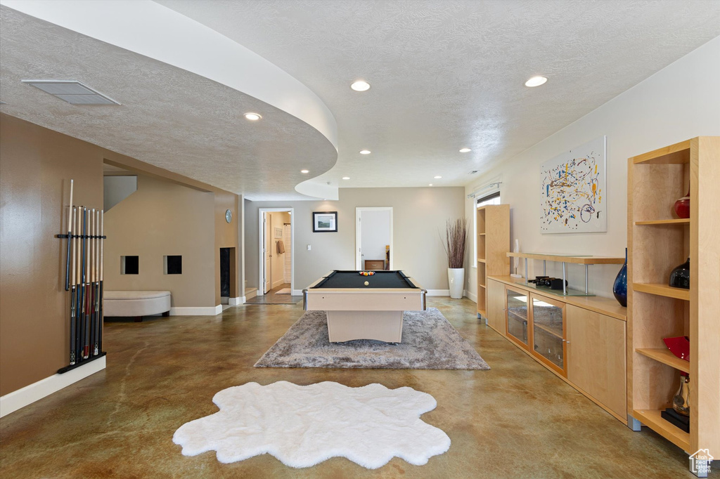 Recreation room with finished concrete flooring, baseboards, billiards, a textured ceiling, and recessed lighting