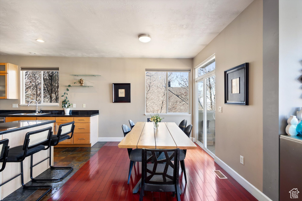 Dining space with baseboards, dark wood-style floors, and recessed lighting