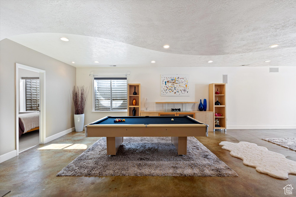 Rec room featuring baseboards, a textured ceiling, billiards table, recessed lighting, and finished concrete floors