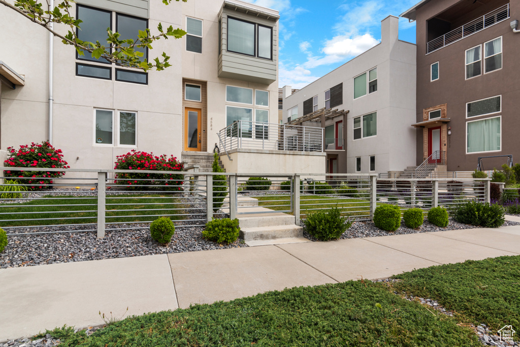 View of building exterior featuring a fenced front yard