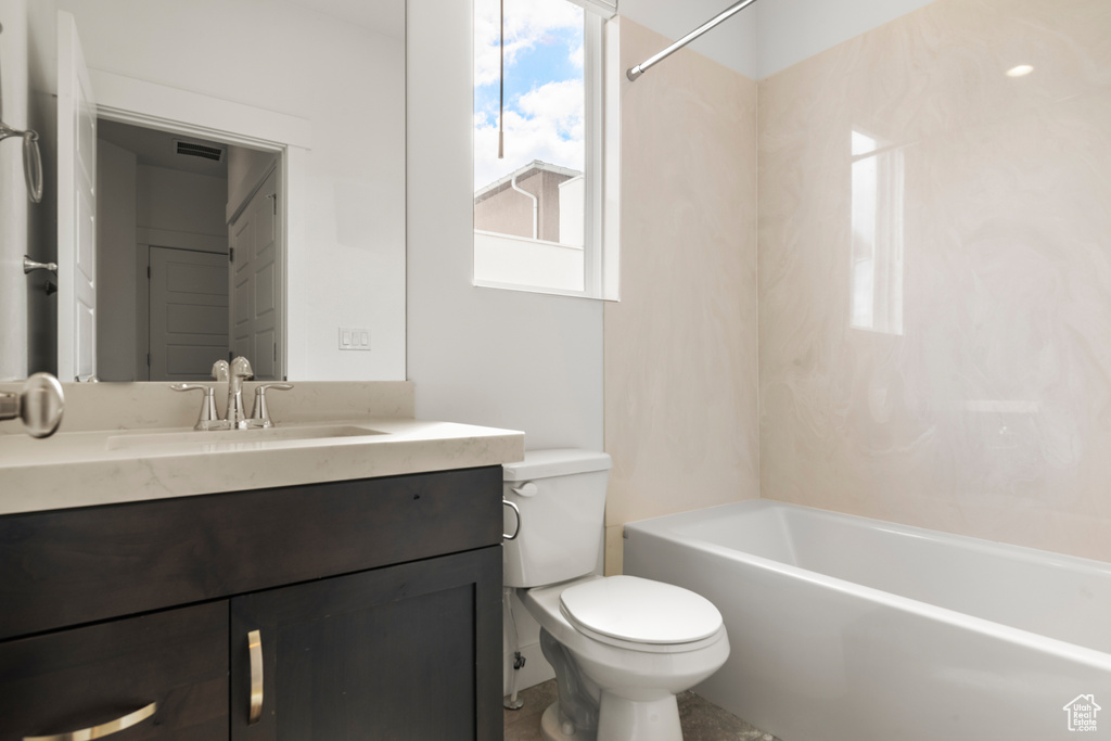 Full bath featuring toilet, vanity, and bathtub / shower combination