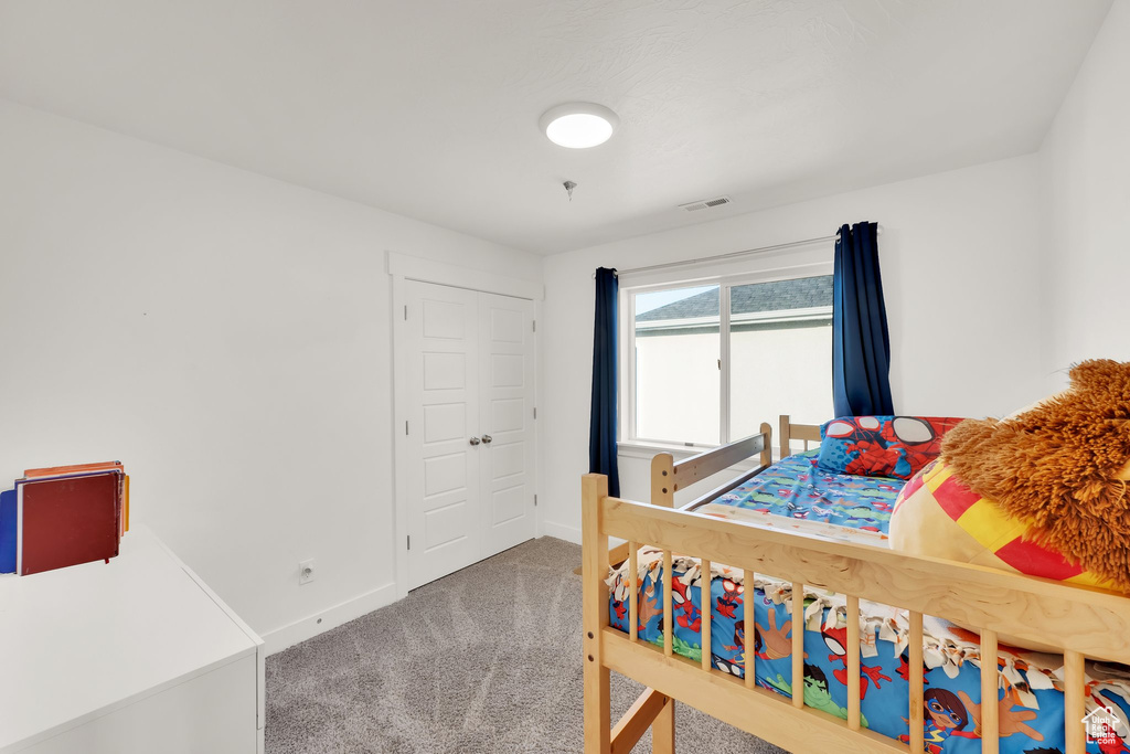 Carpeted bedroom with baseboards