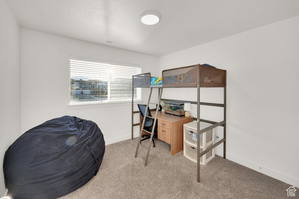 Home office featuring light carpet and baseboards
