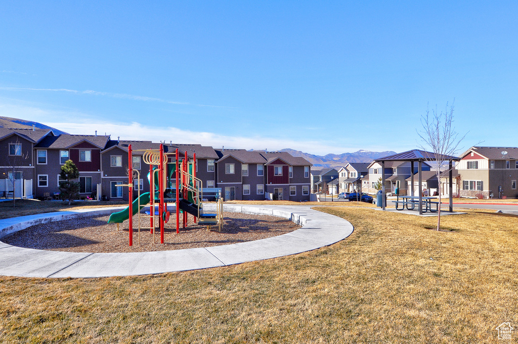 Community play area with a residential view and a lawn