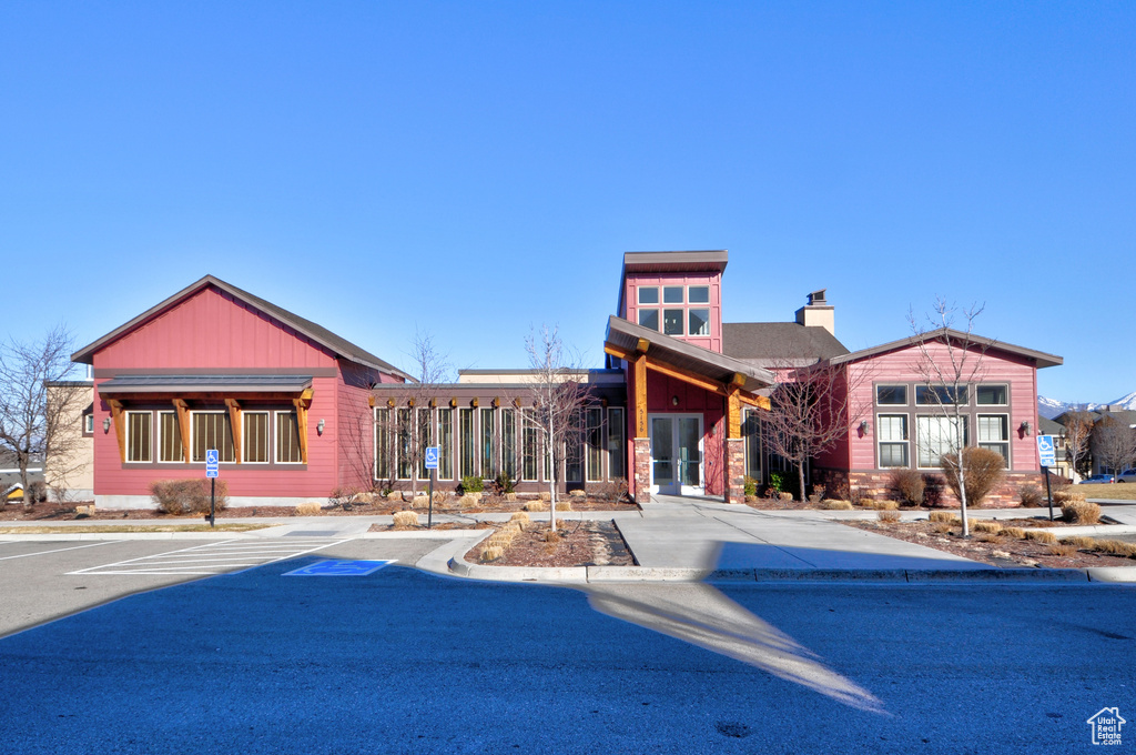 View of property featuring uncovered parking