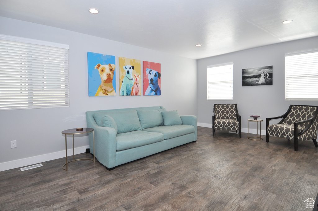 Living area with recessed lighting, wood finished floors, and baseboards