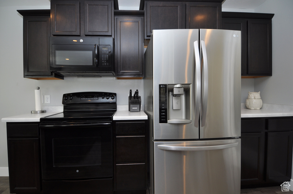 Kitchen featuring black appliances and light countertops
