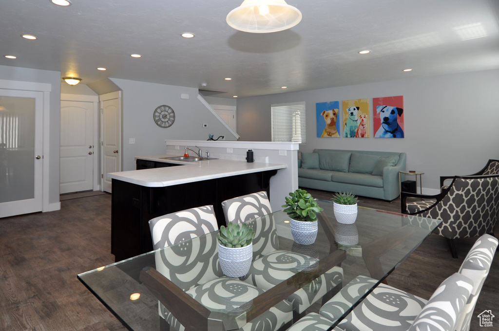 Dining space featuring dark wood-style floors and recessed lighting