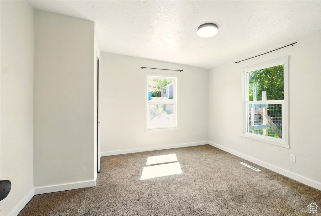 Unfurnished room with carpet floors and baseboards