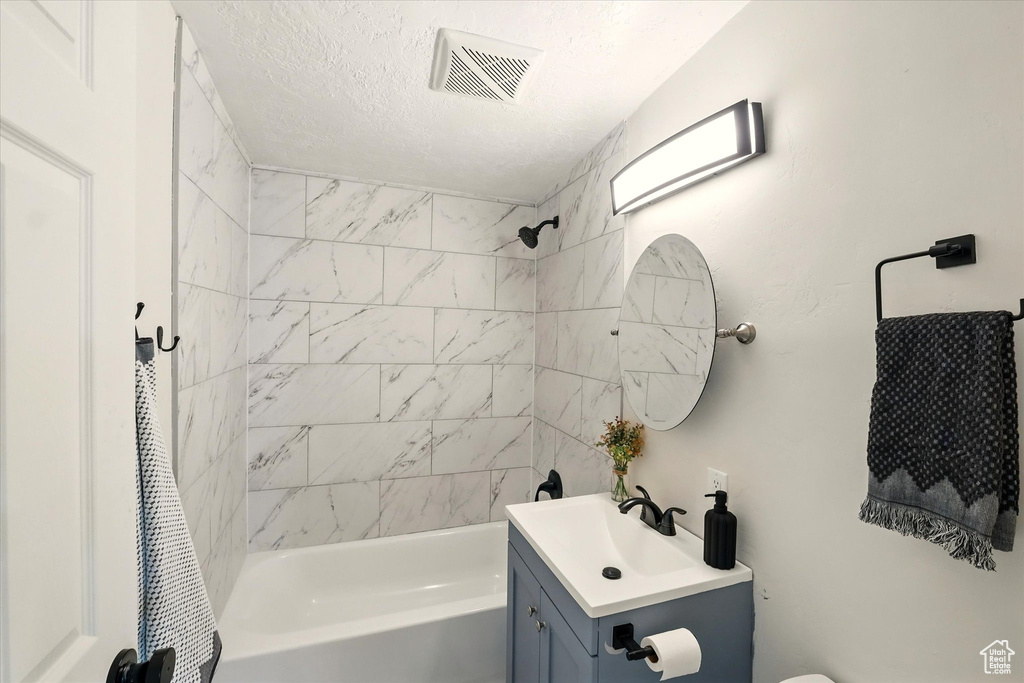 Bathroom featuring shower / bath combination with curtain and vanity