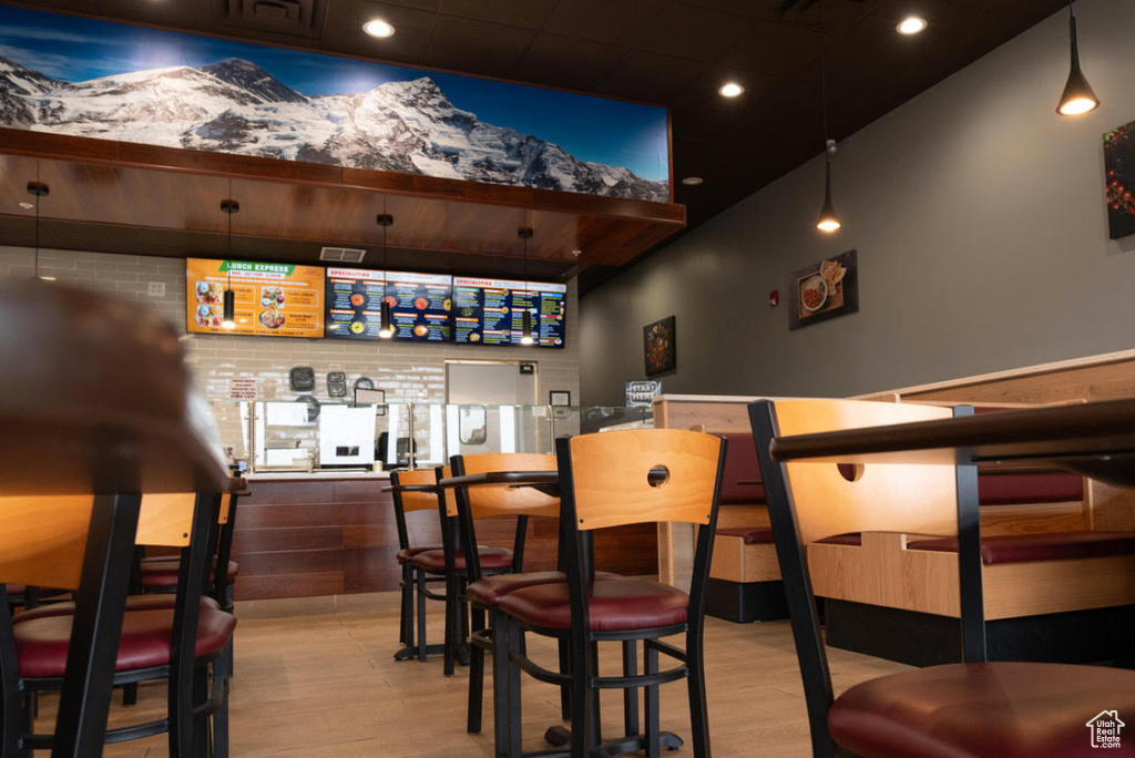 Bar with wood finished floors and recessed lighting