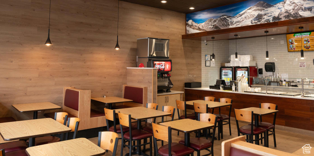 Bar area with recessed lighting, wood finished floors, and wood walls