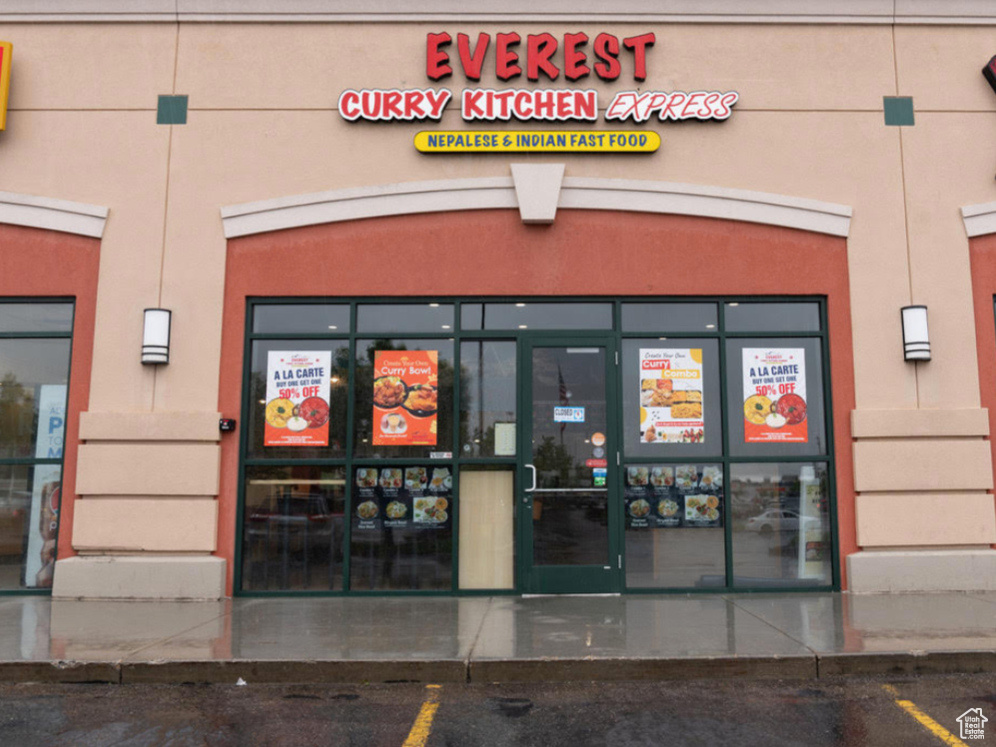 View of building exterior featuring uncovered parking