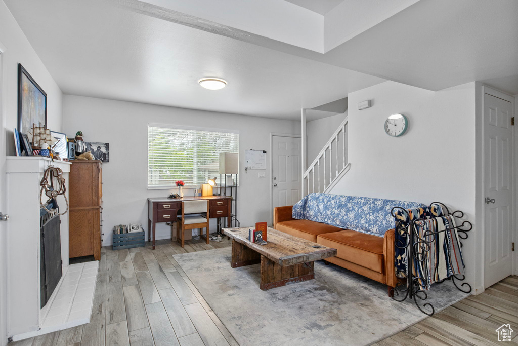 Living room with light wood-style flooring and stairway