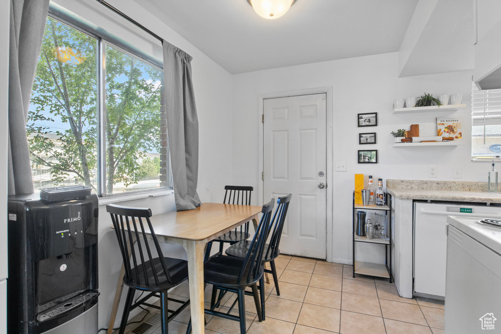 Dining room with healthy amount of natural light and light tile patterned floors