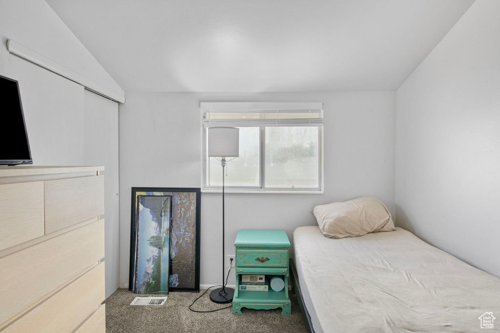 Carpeted bedroom with vaulted ceiling