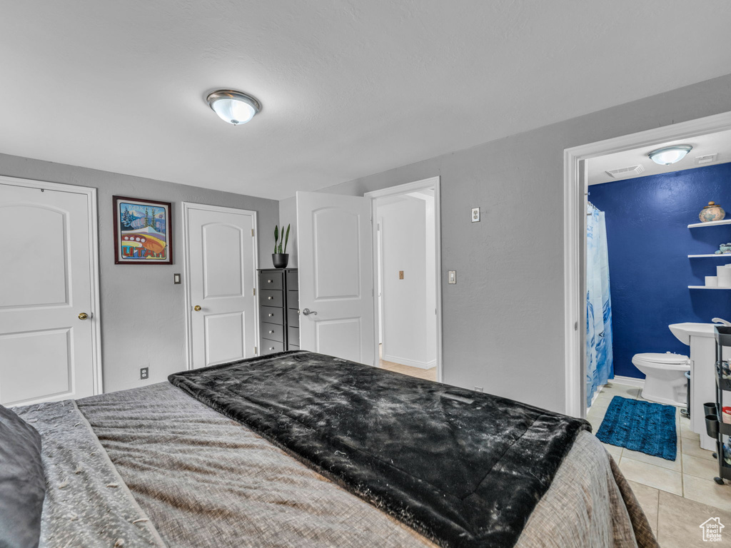 Bedroom with tile patterned flooring and ensuite bath
