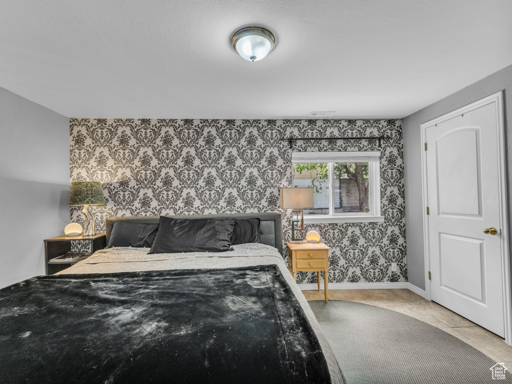 Bedroom featuring wallpapered walls and baseboards