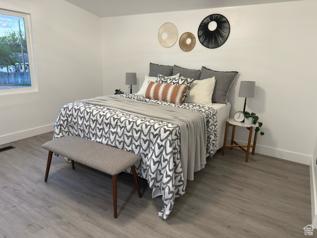 Bedroom featuring baseboards and wood finished floors