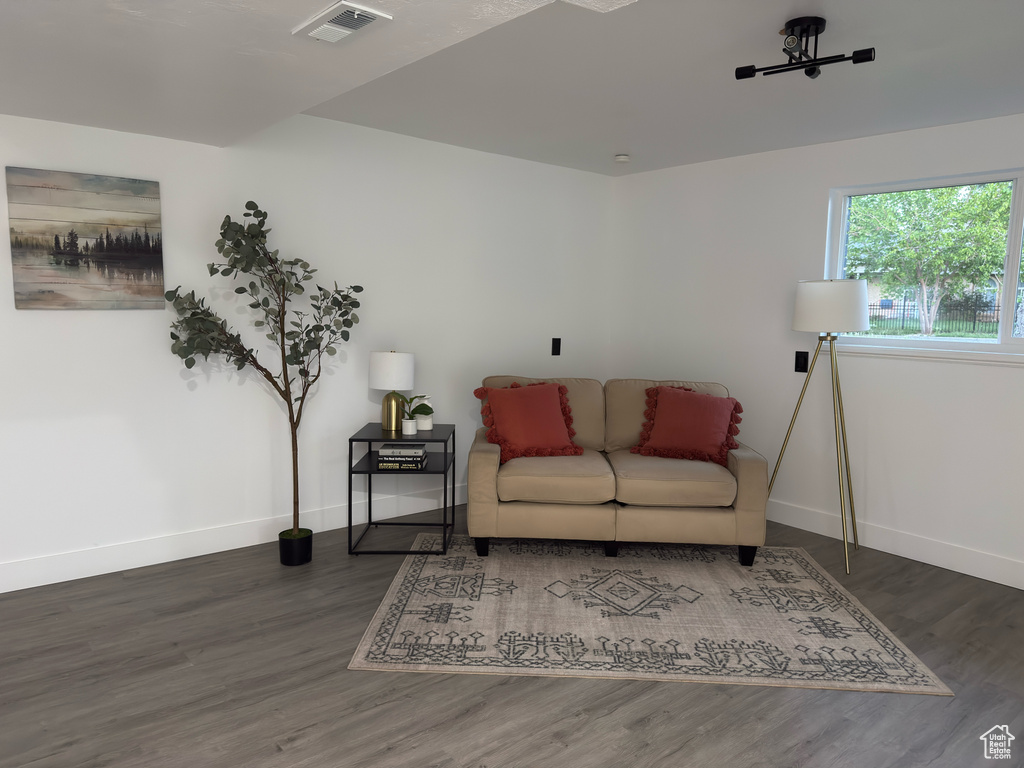 Living area with baseboards and wood finished floors