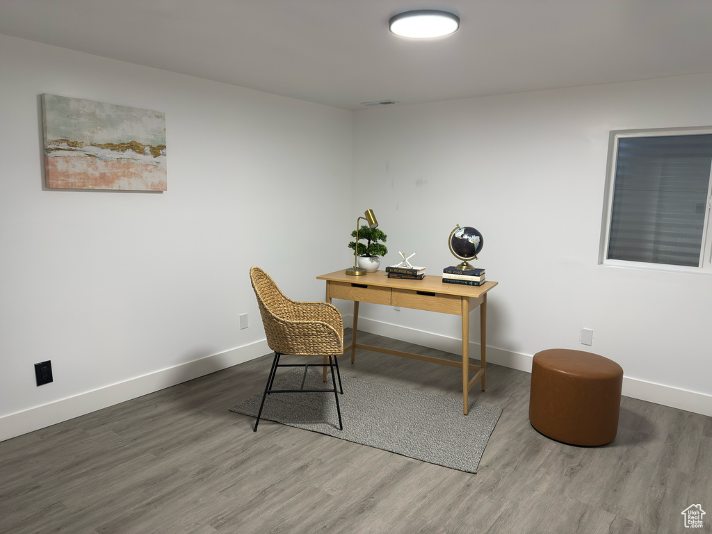 Office space with wood finished floors and baseboards