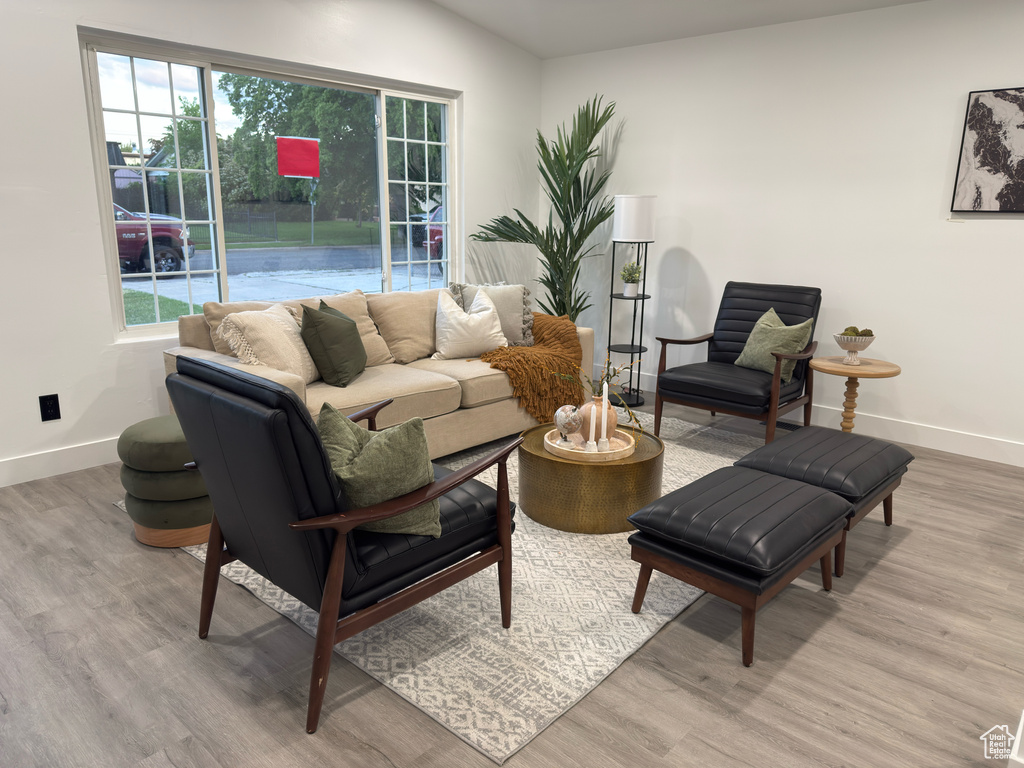 Living room with baseboards and light wood-style floors