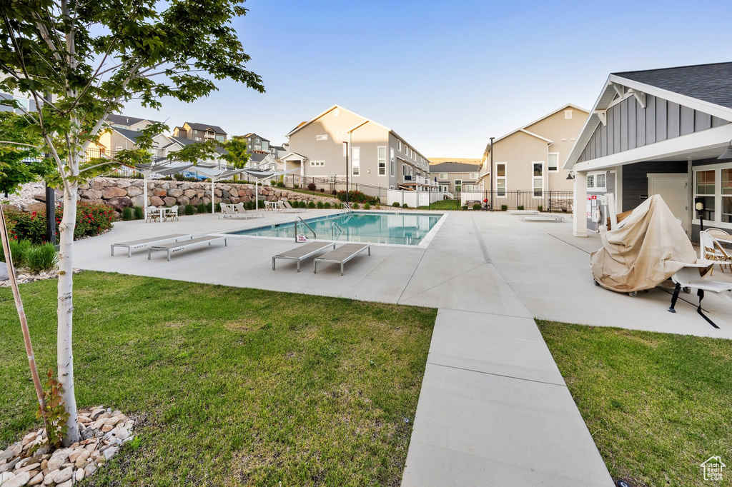 View of swimming pool featuring a patio and a residential view
