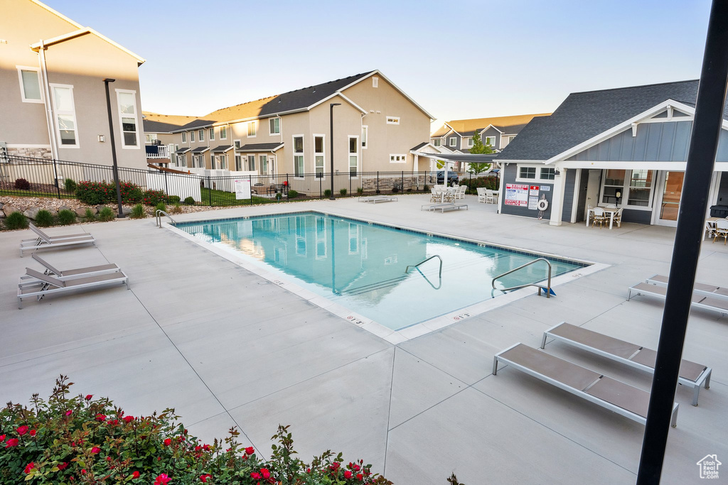 Community pool featuring a patio and a residential view
