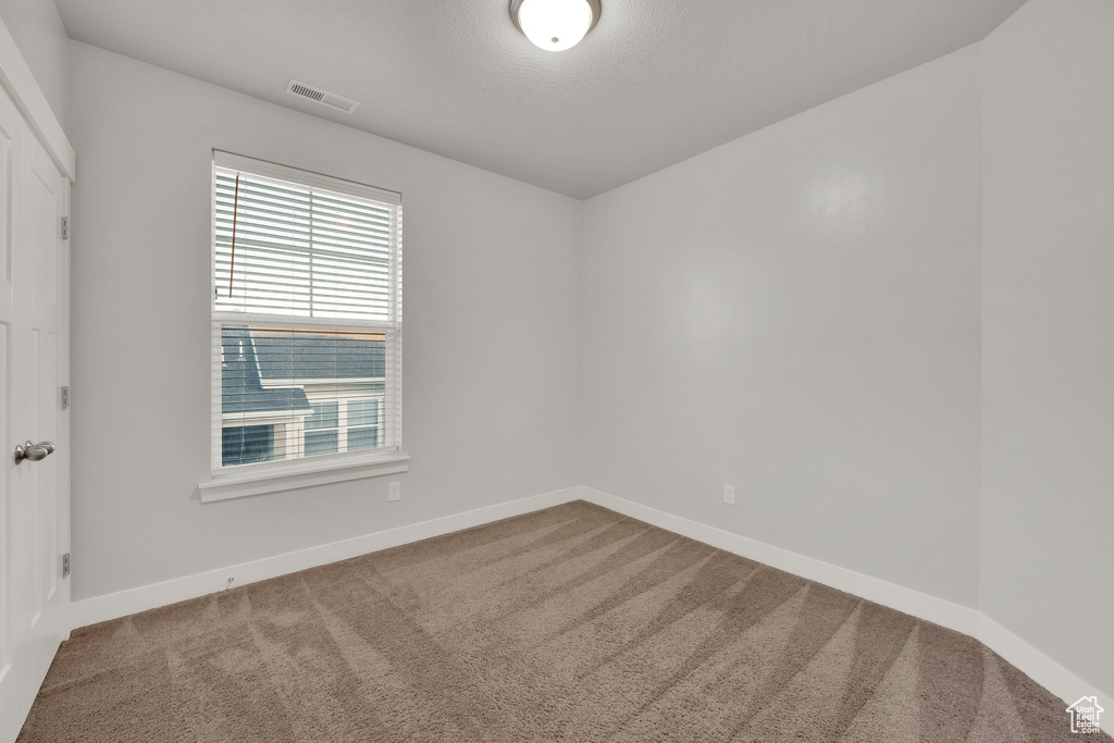 Unfurnished room with carpet and baseboards