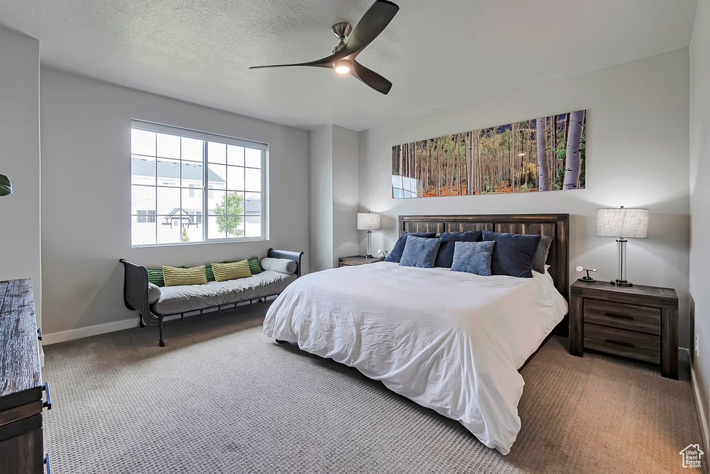 Bedroom featuring carpet flooring, a ceiling fan, and baseboards