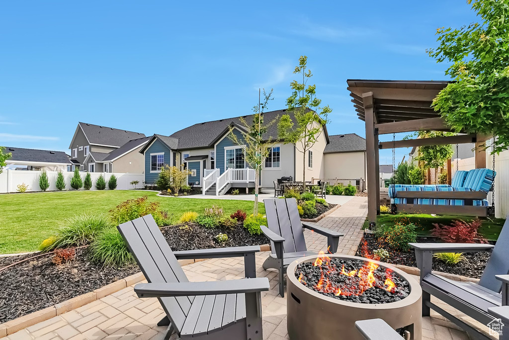 View of patio / terrace featuring an outdoor fire pit and a residential view