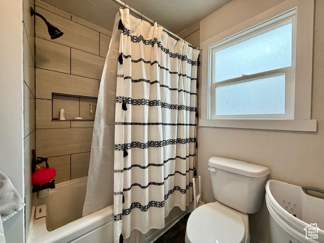 Bathroom featuring toilet and shower / tub combo