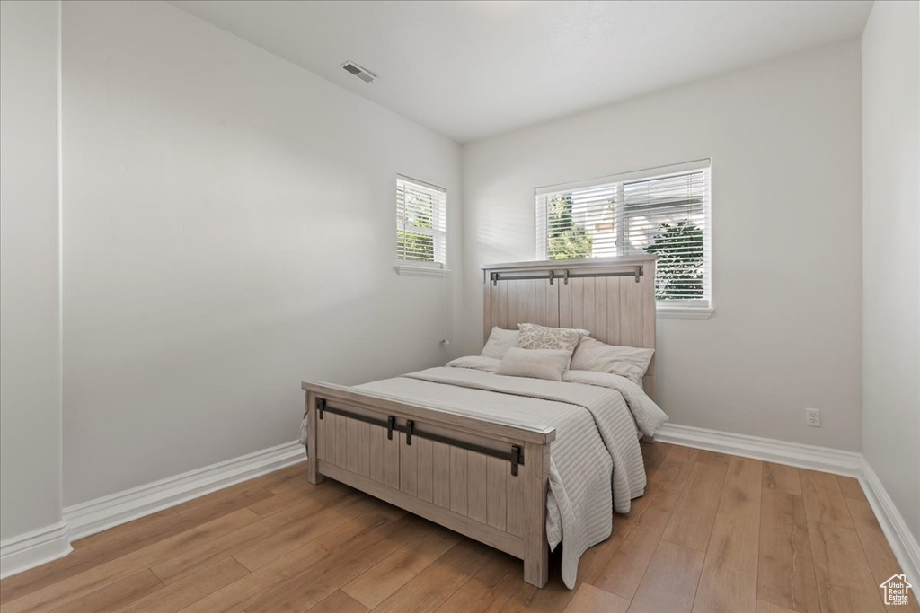 Bedroom with light wood-style floors and baseboards