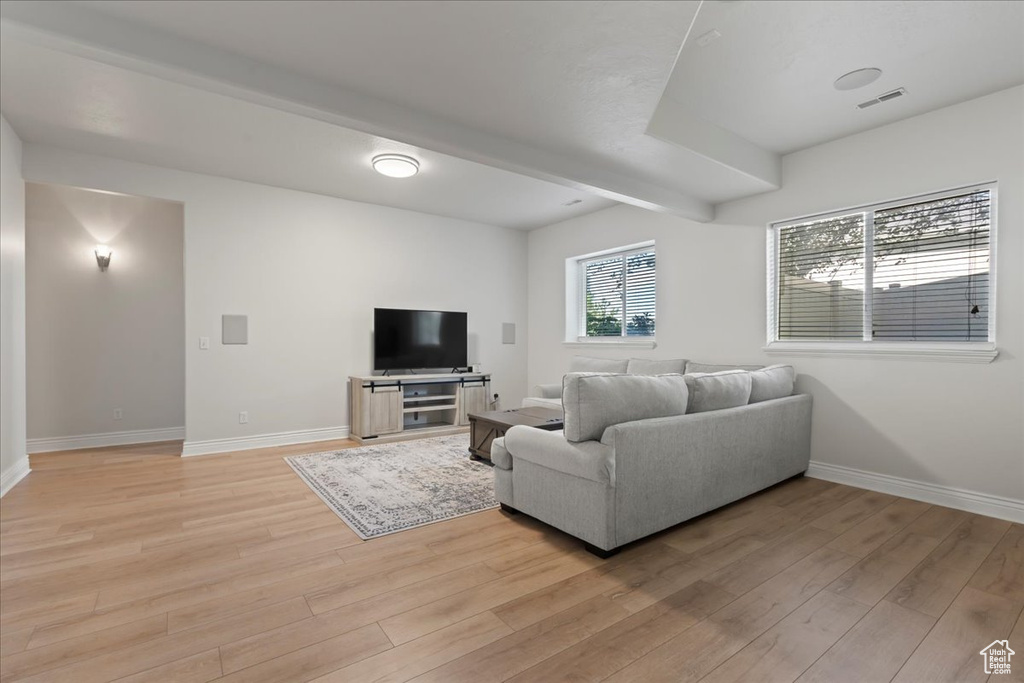 Living room featuring light wood-type flooring and baseboards