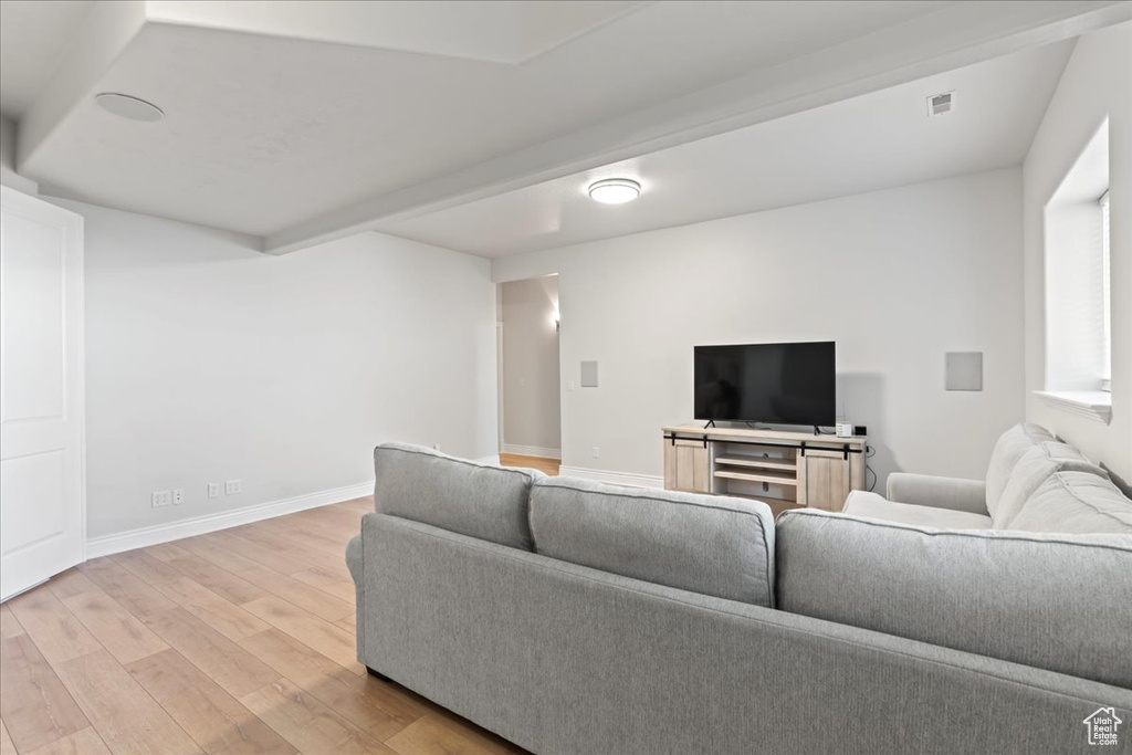Living room featuring light wood-type flooring and baseboards
