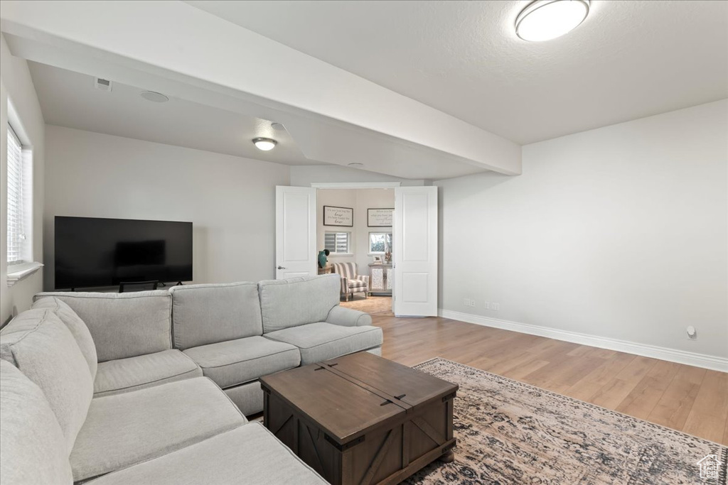 Living area with light wood-style floors and baseboards