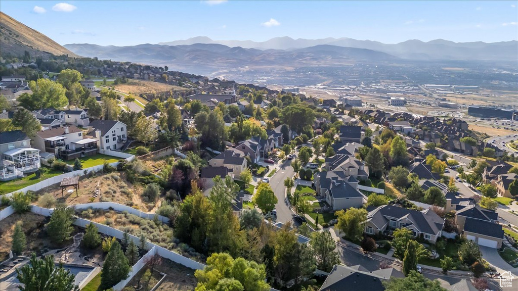Aerial overview of property's location with mountains and nearby suburban area