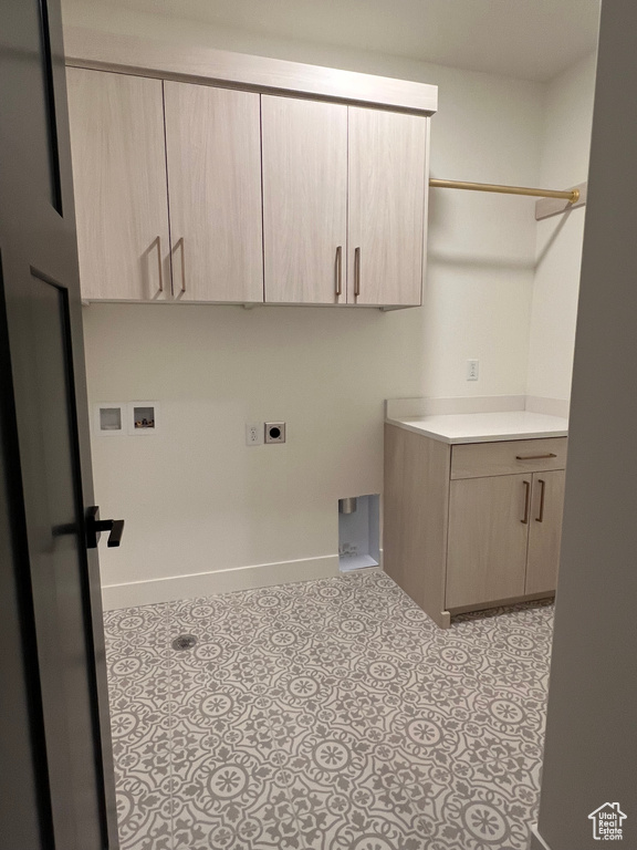 Laundry room featuring electric dryer hookup, washer hookup, cabinet space, and baseboards